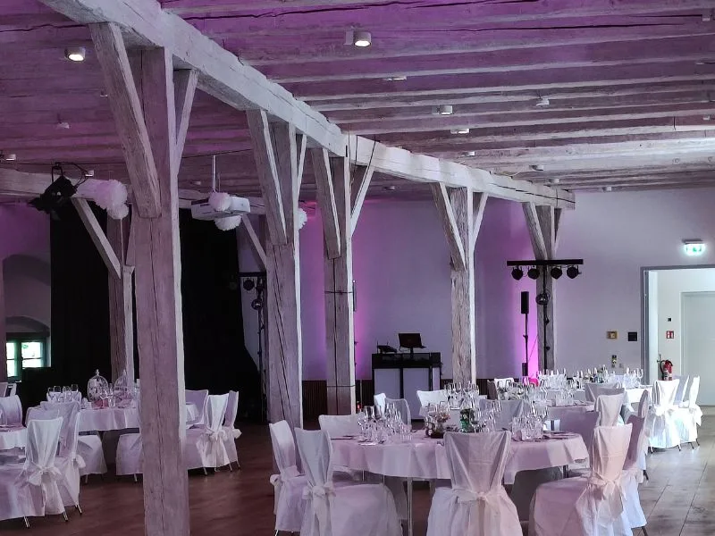 Wittelsbacher Schloss Friedberg – festlich gedeckter Rittersaal mit Holzbalken und Ambientelicht